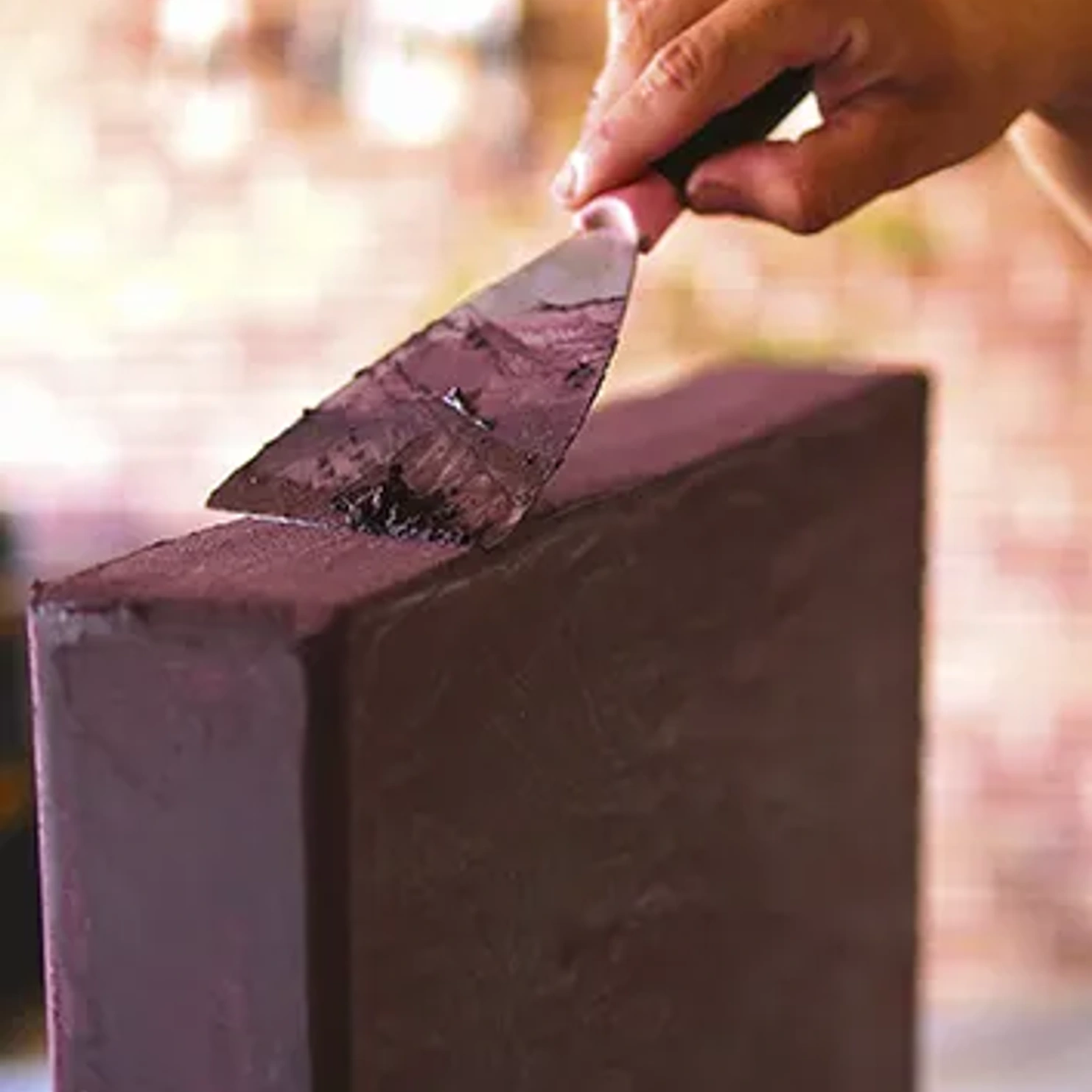 Artisan applying material by hand