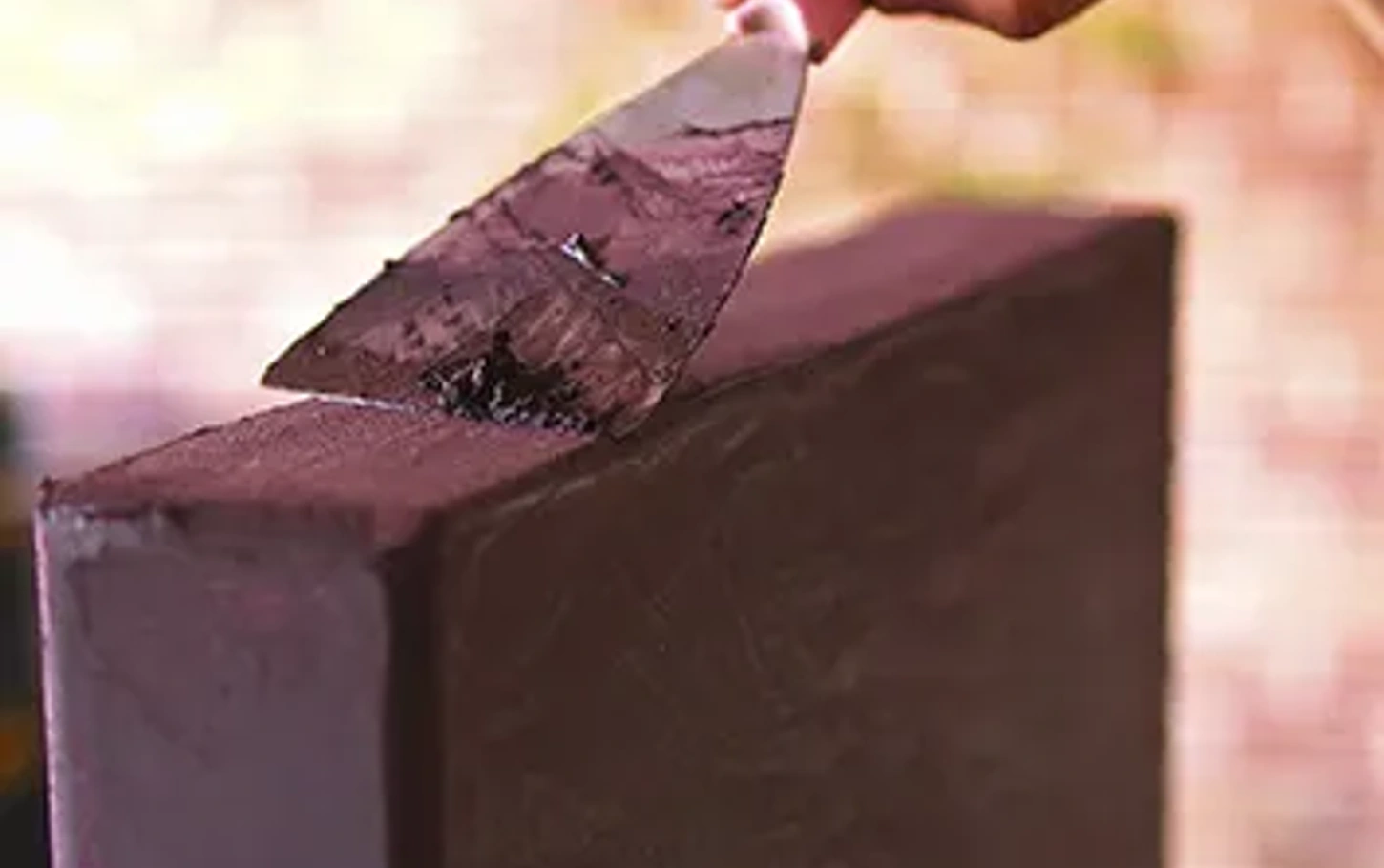 Artisan crafting a microcement surface by hand